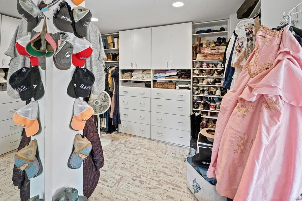 A walk-in closet with integrated lighting and shoe display (as-is)